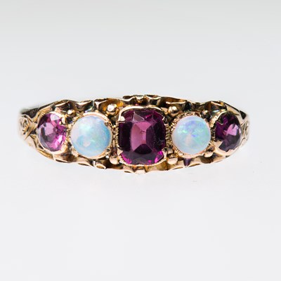 Lot 493 - A VICTORIAN 15 CARAT GOLD GARNET AND OPAL RING