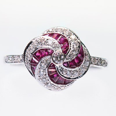Lot 440 - AN 18 CARAT WHITE GOLD RUBY AND DIAMOND CLUSTER RING