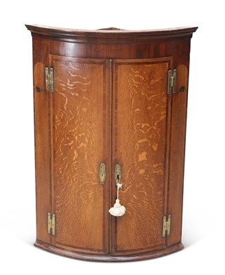 Lot 801 - A GEORGE III OAK AND MAHOGANY HANGING CORNER CABINET