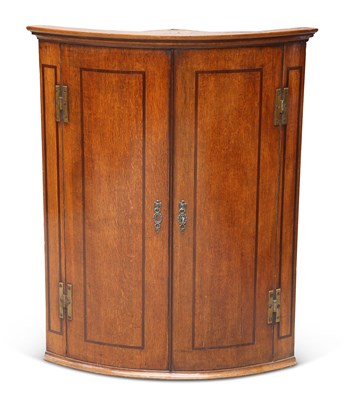 Lot 831 - A GEORGE III MAHOGANY-BANDED OAK HANGING CORNER CUPBOARD