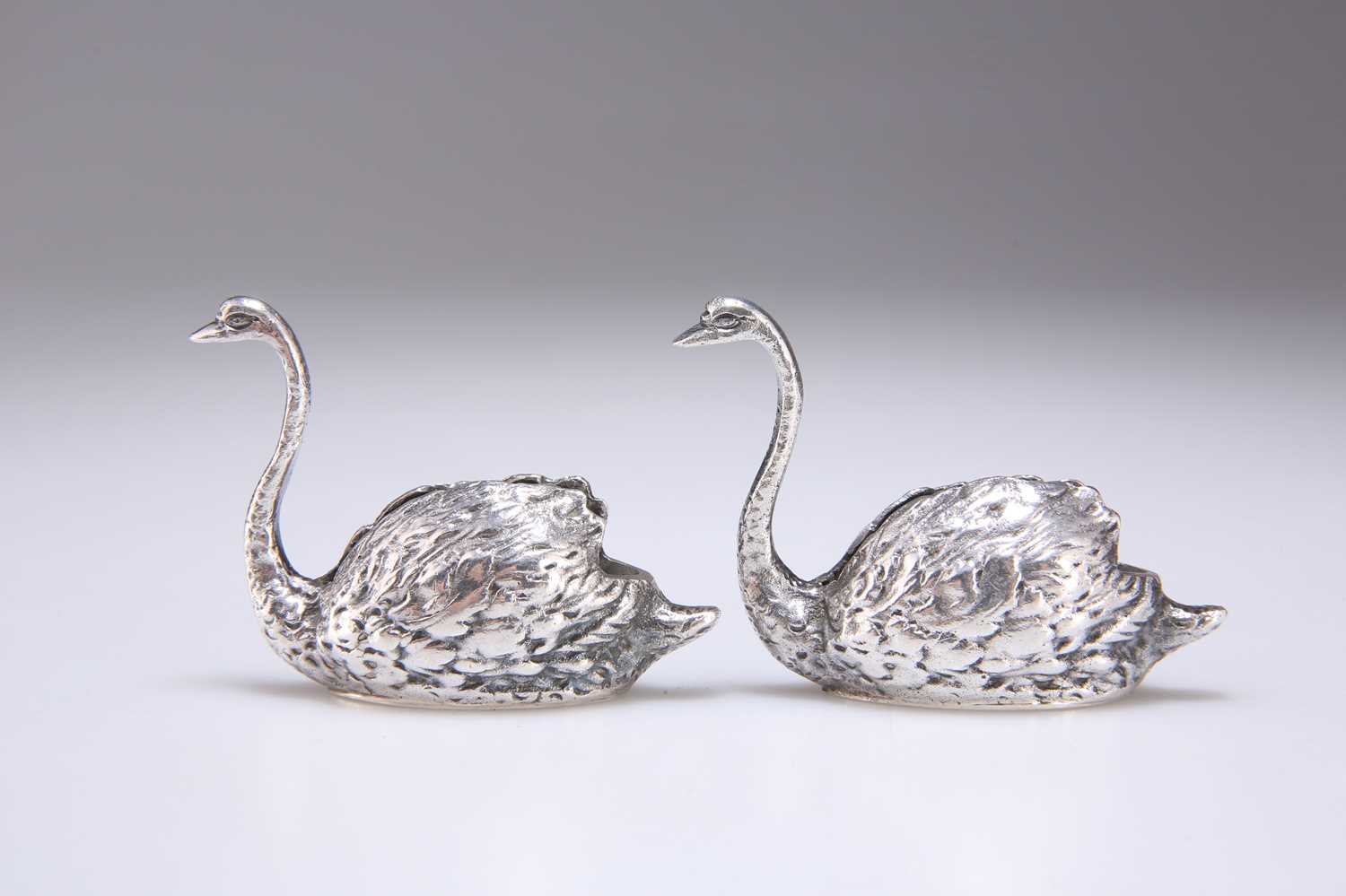 Lot 254 - A PAIR OF ELIZABETH II SILVER MODELS OF SWANS