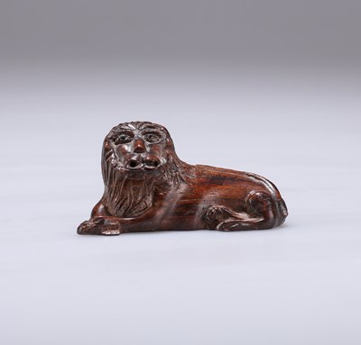 Lot 34 - TREEN: AN EARLY 19TH CENTURY CARVING OF A RECUMBENT LION