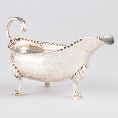 Lot 379 - A GEORGE III SILVER CREAM BOAT