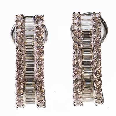 Lot 501 - A PAIR OF 18 CARAT WHITE GOLD DIAMOND HALF HOOP EARRINGS