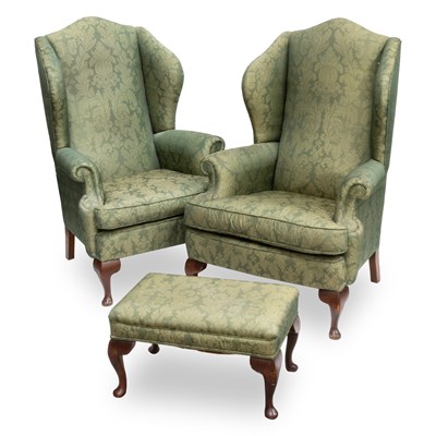 Lot 654 - A PAIR OF GEORGIAN STYLE UPHOLSTERED WING-BACK ARMCHAIRS AND A FOOTSTOOL