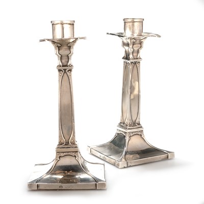 Lot 196 - A PAIR OF ARTS AND CRAFTS SILVER CANDLESTICKS