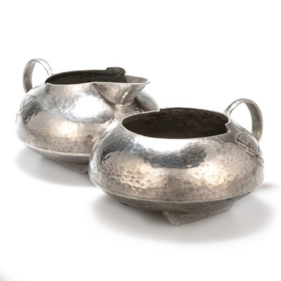 Lot 1099 - ARCHIBALD KNOX (1864-1933) FOR LIBERTY & CO,  A TUDRIC PEWTER SUGAR BOWL AND CREAM JUG