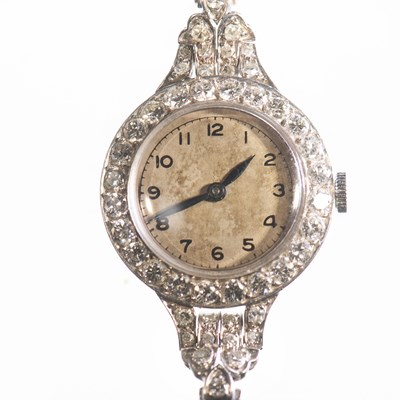 Lot 495 - A LADY'S PLATINUM AND 9CT GOLD DIAMOND-SET BRACELET WATCH