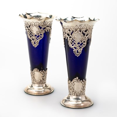 Lot 436 - A PAIR OF EDWARDIAN SILVER AND BLUE GLASS VASES