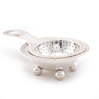 Lot 247 - A NEOCLASSICAL-STYLE GERMAN SILVER TEA STRAINER ON STAND