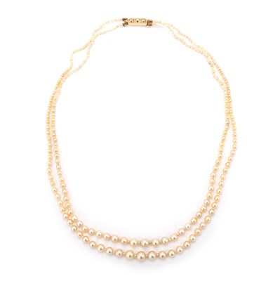 Lot 604 - A NATURAL SALTWATER DOUBLE STRAND GRADUATED PEARL NECKLACE