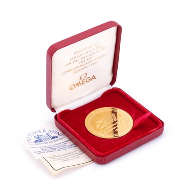 Lot 477 - A THE TOWER MINT COMMEMORATIVE GOLD PLATED OMEGA MEDALLION