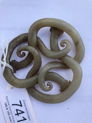Lot 64 - A 19TH CENTURY CHINESE CELADON JADE CARVING OF COILED CHILONG DRAGONS