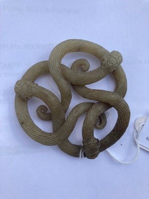 Lot 64 - A 19TH CENTURY CHINESE CELADON JADE CARVING OF COILED CHILONG DRAGONS