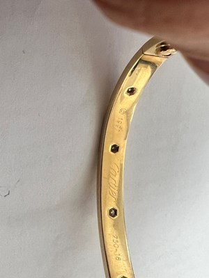 Lot 605 - A CARTIER 18 CARAT GOLD AND DIAMOND LOVE BANGLE WITH BOX AND CERTIFICATION
