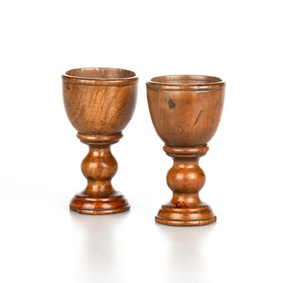 Lot A PAIR OF 19TH CENTURY TREEN EGG CUPS