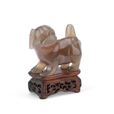 Lot 175 - A CHINESE JADE CARVING ON A HARDWOOD STAND