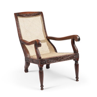 Lot 811 - A 19TH CENTURY CEYLONESE CARVED HARDWOOD AND CANEWORK PLANTATION CHAIR