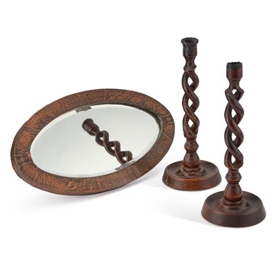 Lot 29 - A SMALL ARTS AND CRAFTS COPPER-MOUNTED OVAL MIRROR AND A PAIR OF OAK OPENTWIST CANDLESTICKS