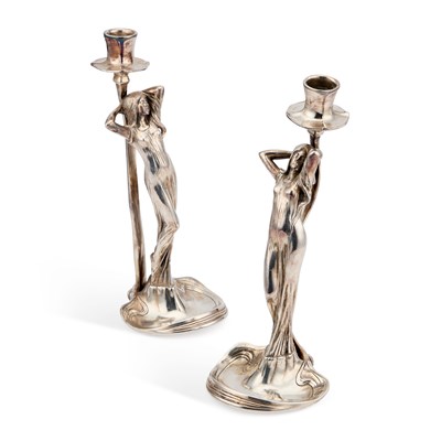 Lot 569 - WMF (WÜRTTEMBERGISCHE METALLWARENFABRIK), A PAIR OF ART NOUVEAU SILVERED METAL FIGURAL CANDLESTICKS