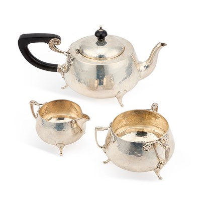 Lot 353 - AN ARTS AND CRAFTS HAMMERED SILVER THREE-PIECE TEA SERVICE