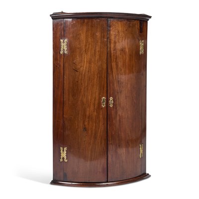 Lot 779 - A GEORGE III MAHOGANY BOW-FRONT HANGING CORNER CUPBOARD