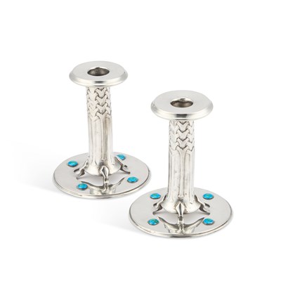 Lot 184 - ARCHIBALD KNOX (1864-1933) FOR LIBERTY & CO, A PAIR OF TUDRIC PEWTER AND ENAMEL CANDLESTICKS