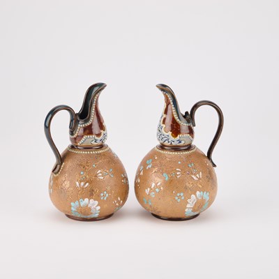 Lot 236 - A PAIR OF DOULTON LAMBETH STONEWARE EWERS