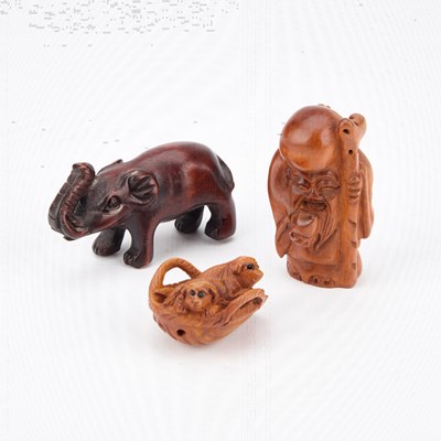 Lot 452 - THREE CARVED WOOD NETSUKES