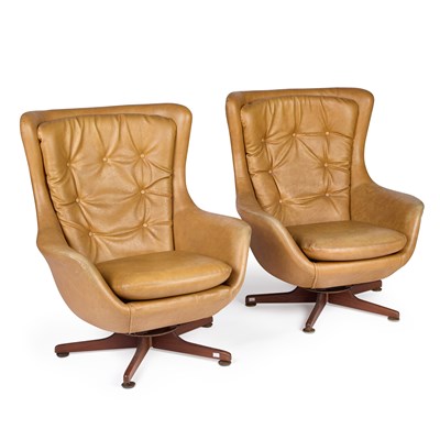 Lot 810 - A PAIR OF 1970'S HARDWOOD AND UPHOLSTERED SWIVELLING EASY CHAIRS