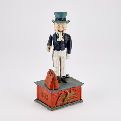 Lot 723 - A NOVELTY PAINTED CAST IRON MONEY BANK