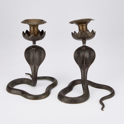 Lot 719 - A PAIR OF DAMASCENED COBRA CANDLESTICKS