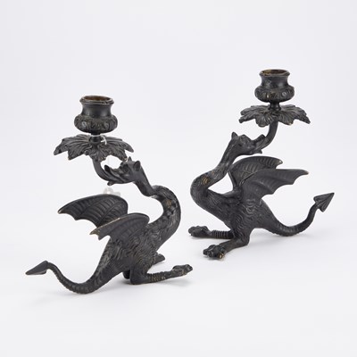 Lot 718 - A PAIR OF PATINATED BRONZE GRIFFIN CANDLESTICKS