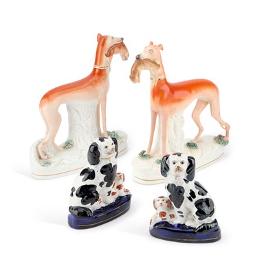 Lot 63 - A NEAR PAIR OF VICTORIAN STAFFORDSHIRE POTTERY MODELS OF GREYHOUNDS