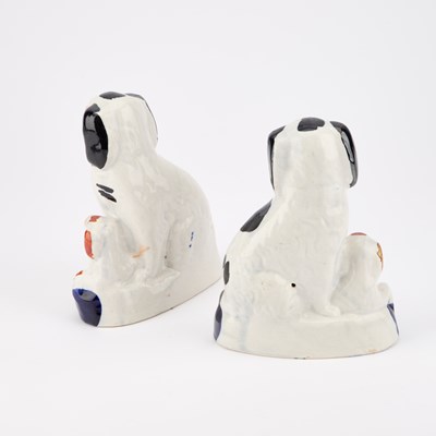 Lot 63 - A NEAR PAIR OF VICTORIAN STAFFORDSHIRE POTTERY MODELS OF GREYHOUNDS