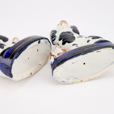 Lot 63 - A NEAR PAIR OF VICTORIAN STAFFORDSHIRE POTTERY MODELS OF GREYHOUNDS