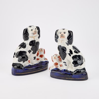 Lot 63 - A NEAR PAIR OF VICTORIAN STAFFORDSHIRE POTTERY MODELS OF GREYHOUNDS