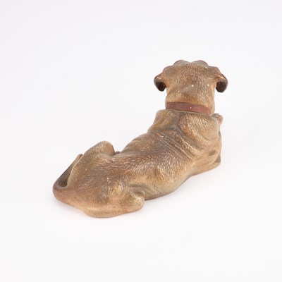 Lot 826 - AN AUSTRIAN PAINTED TERRACOTTA MODEL OF A RECUMBENT DOG