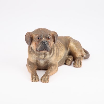 Lot 826 - AN AUSTRIAN PAINTED TERRACOTTA MODEL OF A RECUMBENT DOG