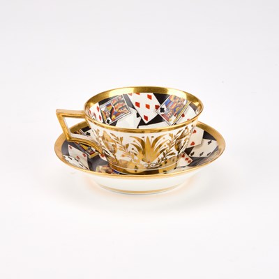 Lot 51 - A RARE DERBY TROMPE L'OEIL 'PLAYING CARDS' CUP AND SAUCER, CIRCA 1815