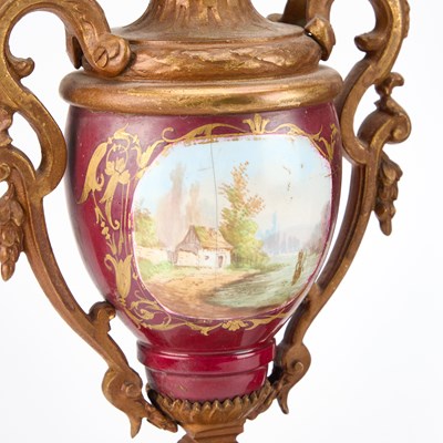 Lot A LATE 19TH CENTURY FRENCH GILT-METAL AND MAGENTA-GROUND PORCELAIN CLOCK GARNITURE