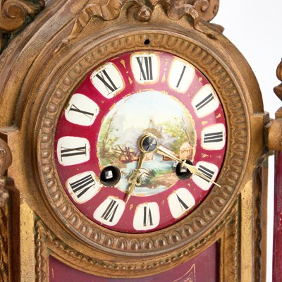 Lot A LATE 19TH CENTURY FRENCH GILT-METAL AND MAGENTA-GROUND PORCELAIN CLOCK GARNITURE