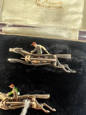 Lot A PAIR OF EARLY 20TH CENTURY DIAMOND AND ENAMEL JOCKEY BROOCHES