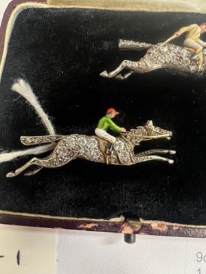 Lot A PAIR OF EARLY 20TH CENTURY DIAMOND AND ENAMEL JOCKEY BROOCHES