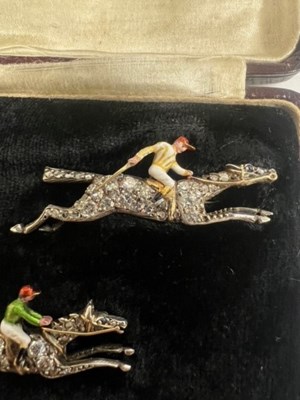 Lot A PAIR OF EARLY 20TH CENTURY DIAMOND AND ENAMEL JOCKEY BROOCHES