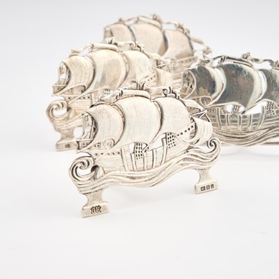 Lot 462 - OMAR RAMSDEN: AN SET OF FOUR ARTS AND CRAFTS SILVER MENU HOLDERS