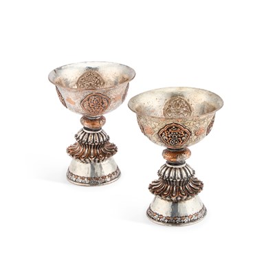 Lot 349 - A PAIR OF TIBETAN DIPA SILVER ON COPPER BUTTER OIL LAMPS