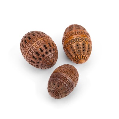 Lot 287 - THREE PIERCED AND CARVED COQUILLA NUTS