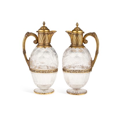 Lot 514 - A FINE PAIR OF EDWARDIAN SILVER-GILT MOUNTED STOURBRIDGE 'ROCK CRYSTAL' GLASS CLARET JUGS