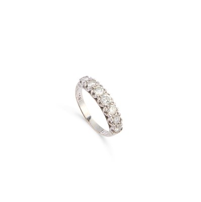 Lot 448 - A SEVEN STONE DIAMOND HALF HOOP RING